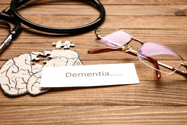 Word Dementia Human Brain Eyeglasses Stethoscope Wooden Background — Stock Photo, Image