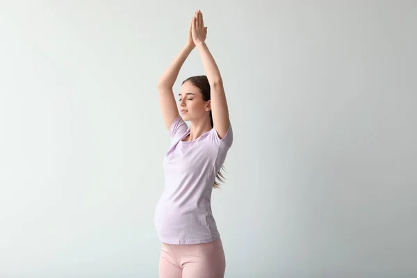 Sporty Pregnant Woman Practicing Yoga Light Wall — Stock Photo, Image