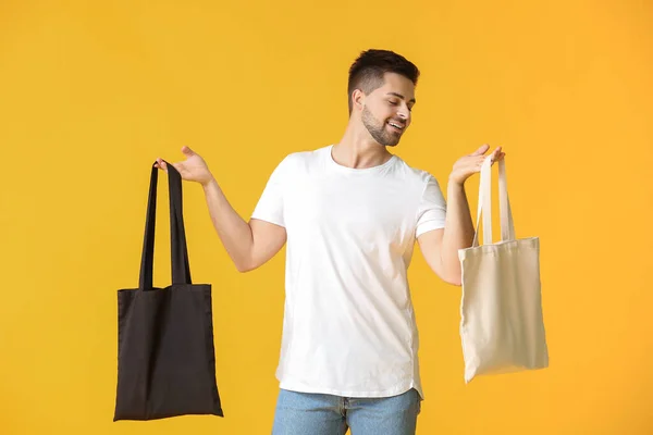 Junger Mann Mit Öko Tüten Auf Farbigem Hintergrund — Stockfoto