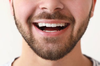 Handsome smiling young man on white background, closeup