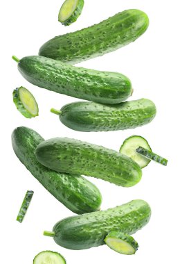 Flying green cucumbers on white background clipart