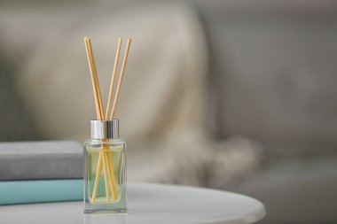 Reed diffuser on table in room clipart