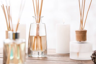 Reed diffusers on table in room clipart