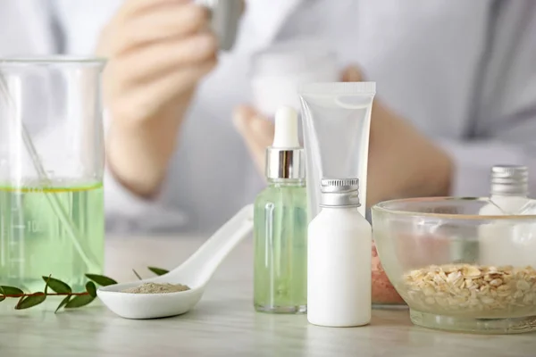 Natural cosmetics with ingredients on table in laboratory