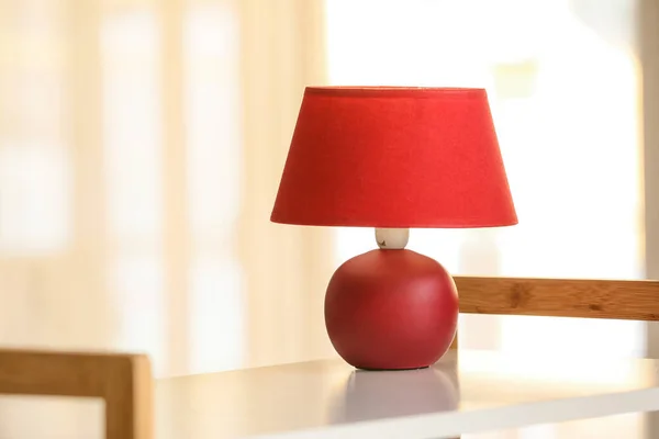 Modern lamp on table in room