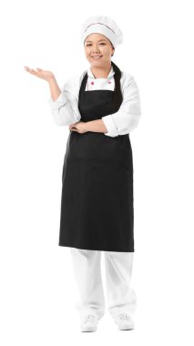 Güzel Asyalı şef beyaz arka planda bir şeyler gösteriyor.