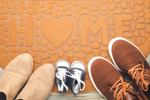 Door mat and shoes on floor