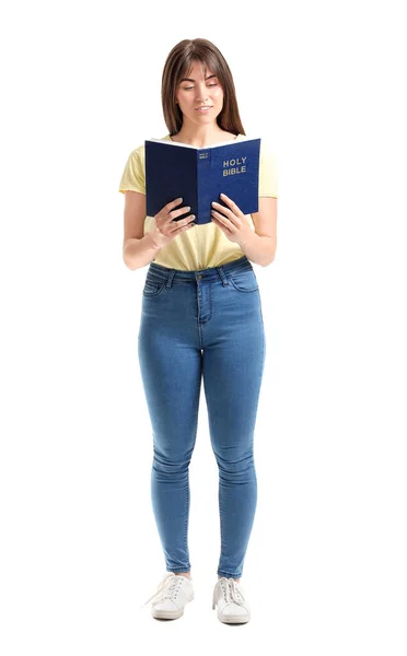 Young woman with Bible on white background