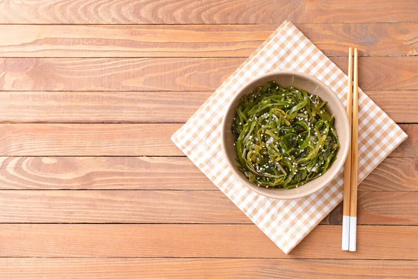 Bowl Tasty Seaweed Chopsticks Wooden Background — Stock Photo, Image