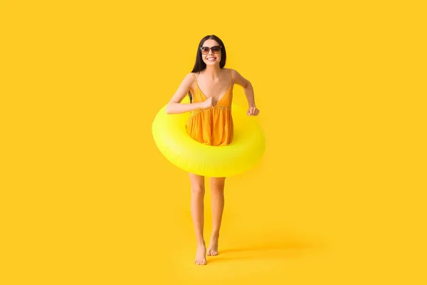 Jumping Young Woman Inflatable Ring Color Background — Stock Photo, Image