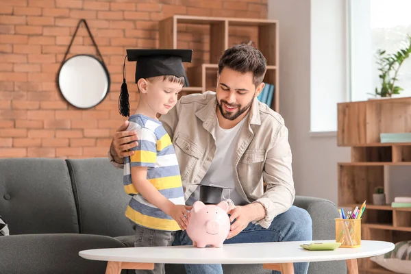 Niño Padre Con Ahorros Para Educación Hogar —  Fotos de Stock