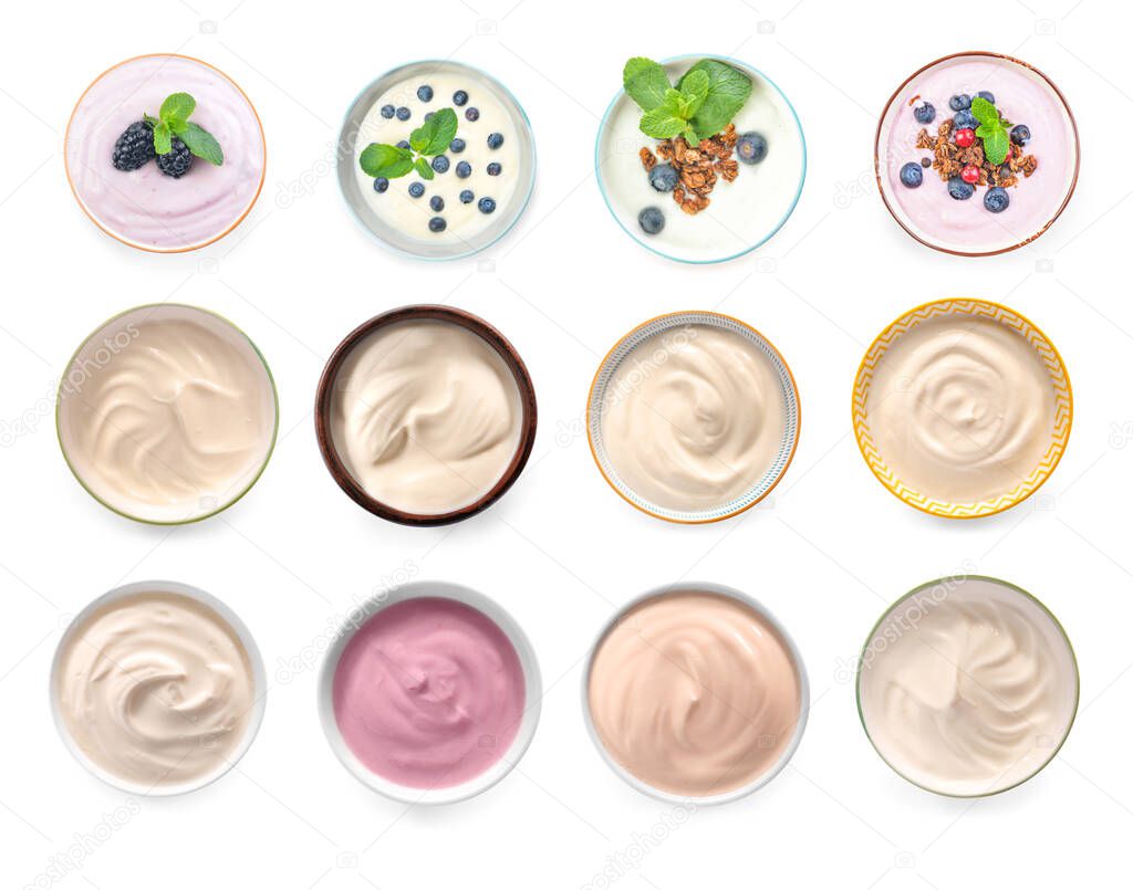 Bowls with different tasty yogurts on white background