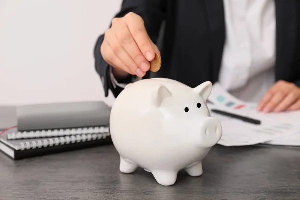 Businesswoman Putting Money Piggy Bank — Stock Photo, Image