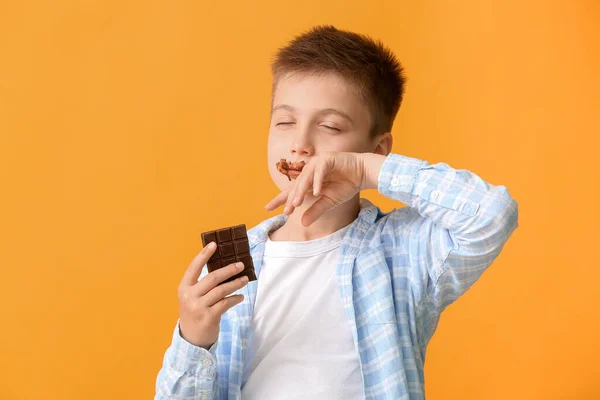 Cute Little Boy Eating Chocolate Color Background — Stock Photo, Image