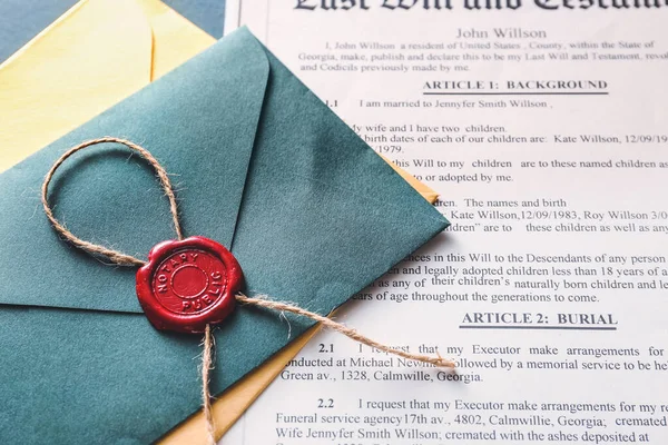 Envelope with notary public wax seal and document on table