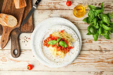 Plate with tasty pasta bolognese on table