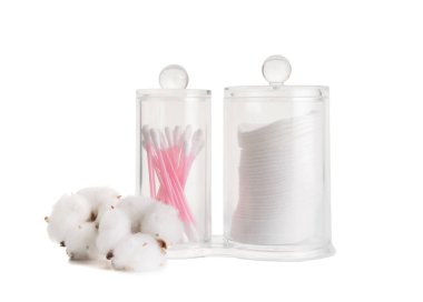 Beyaz arka planda pamuk kozmetik pedleri ve çubuklar