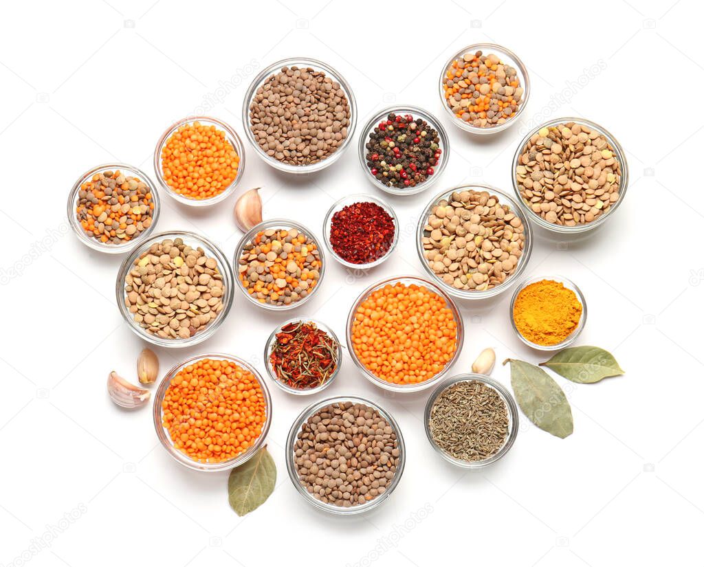 Bowls with lentils and spices on white background