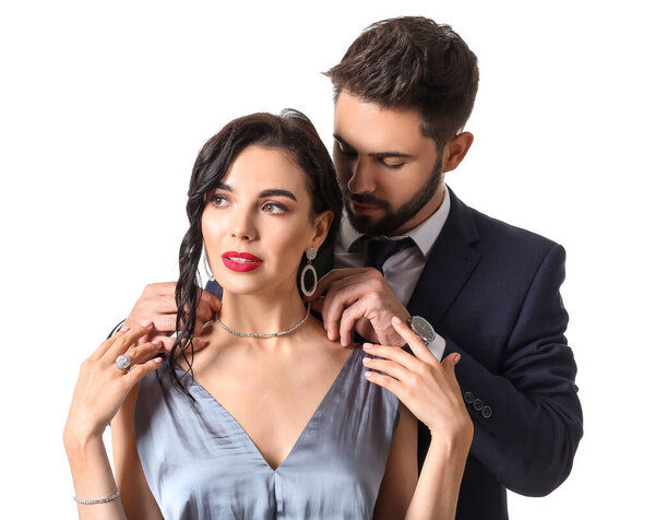 Young couple wearing stylish accessories on white background