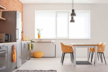 Yemek masası olan modern mutfağın şık iç tasarımı.