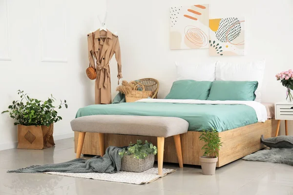 Big bed and bench in interior of modern room