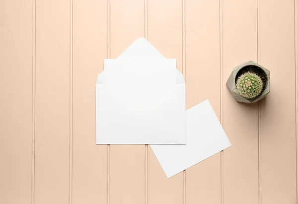 Blank cards with envelope on wooden background