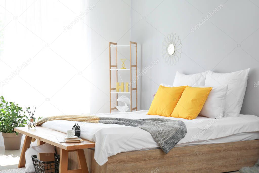 Big bed and bench in interior of modern room