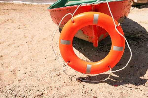 Boat with lifebuoy ring on coast