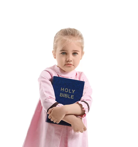 Little girl with Bible on white background