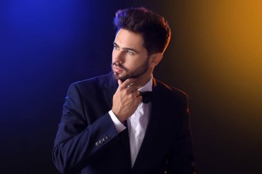 Siyah arka planda şık saç stili olan yakışıklı adam.