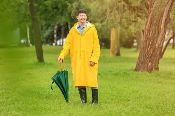 Young Asian Man Umbrella Wearing Raincoat Park — Stock Photo, Image