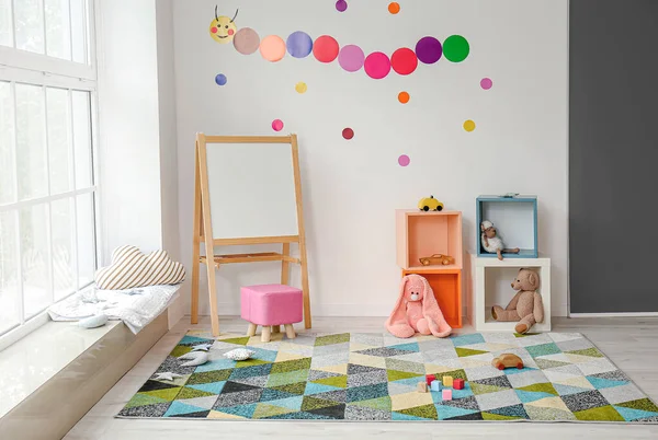 Stylish interior of modern playroom in kindergarten