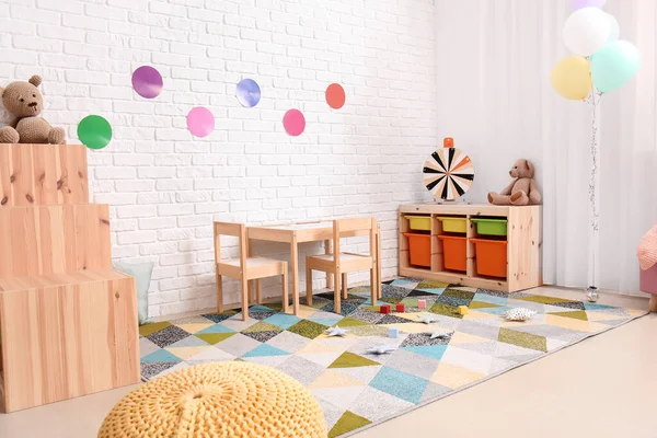 Stylish interior of modern playroom in kindergarten