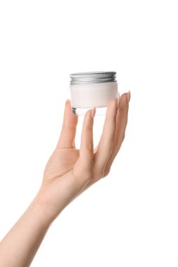 Beyaz arka planda krem sürmüş genç bir kadının eli