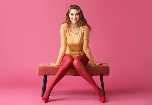 Beautiful Young Woman Tights Sitting Bench Color Background — Stock Photo, Image