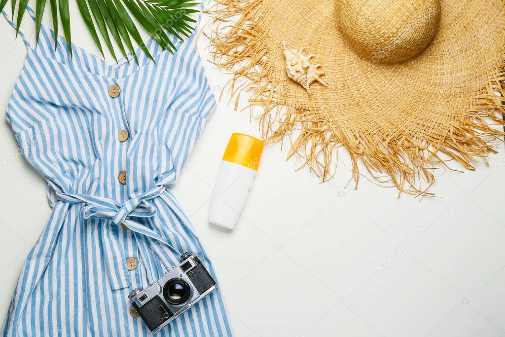 Summer composition with female clothes on light background