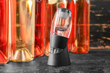 Havacı ve şarap şişeleri koyu arkaplanda.