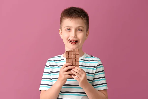 Cute Little Boy Eating Chocolate Color Background — Stock Photo, Image