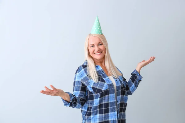 Mature Woman Celebrating Birthday Light Background — Stock Photo, Image