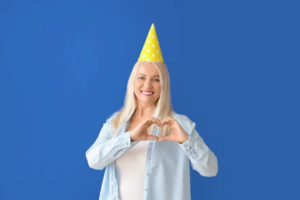 Mature Woman Celebrating Birthday Color Background — Stock Photo, Image