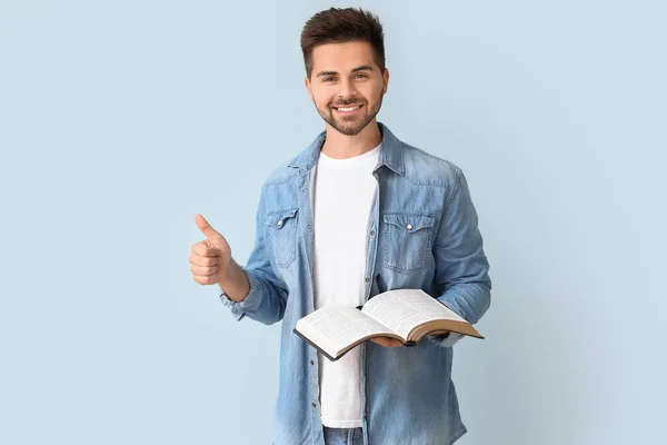 Young Man Bible Showing Thumb Gesture Color Background — Stock Photo, Image