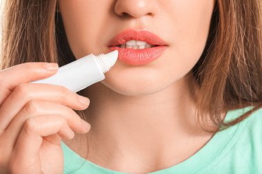 Dudak kremi sürmüş güzel genç bir kadın, yakın plan.