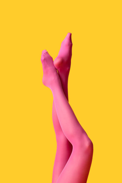 Beautiful young woman in tights on color background