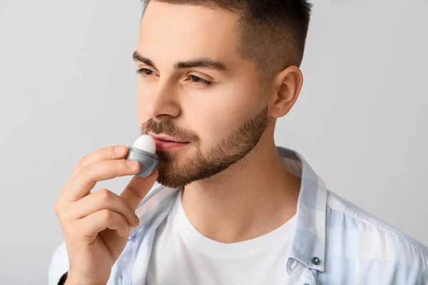 Handsome Young Man Lip Balm Light Background — Stock Photo, Image