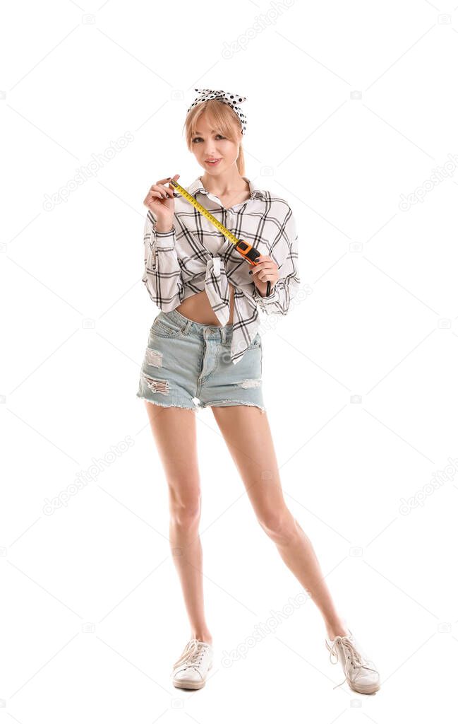 Young woman with tape measure on white background