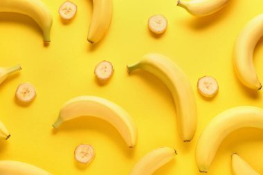 Ripe bananas on color background clipart