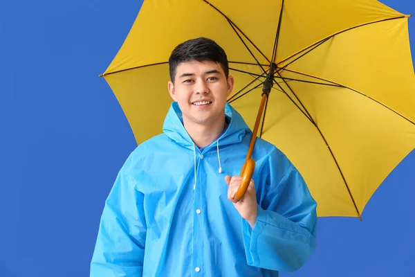 Young Asian Man Raincoat Umbrella Color Background — Stock Photo, Image