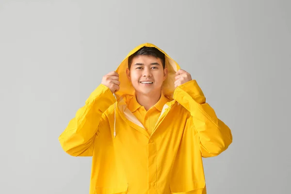 Young Asian Man Raincoat Grey Background — Stock Photo, Image