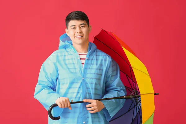 Young Asian Man Raincoat Umbrella Color Background — Stock Photo, Image