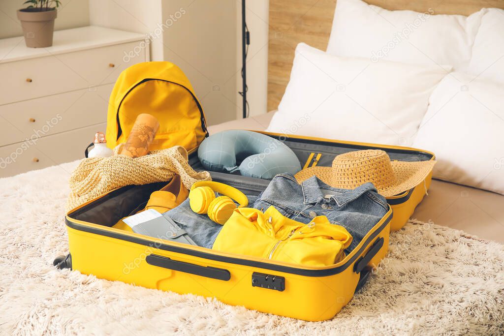 Packed suitcase on bed. Travel concept